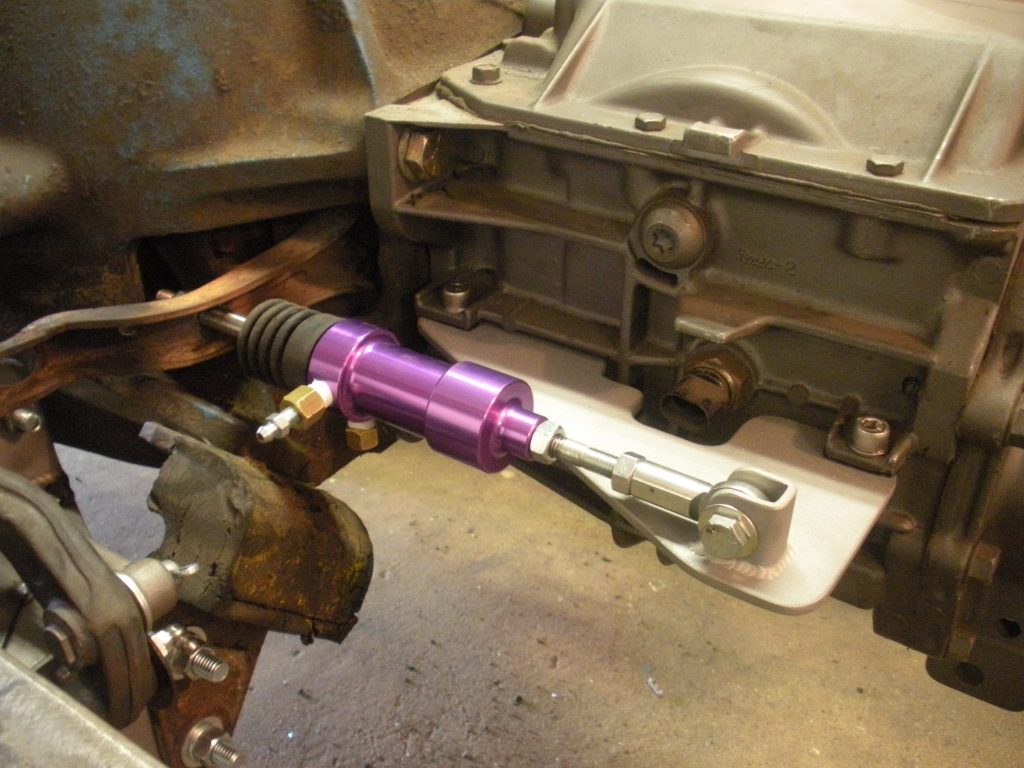 A purple tool is being used to fix an engine.