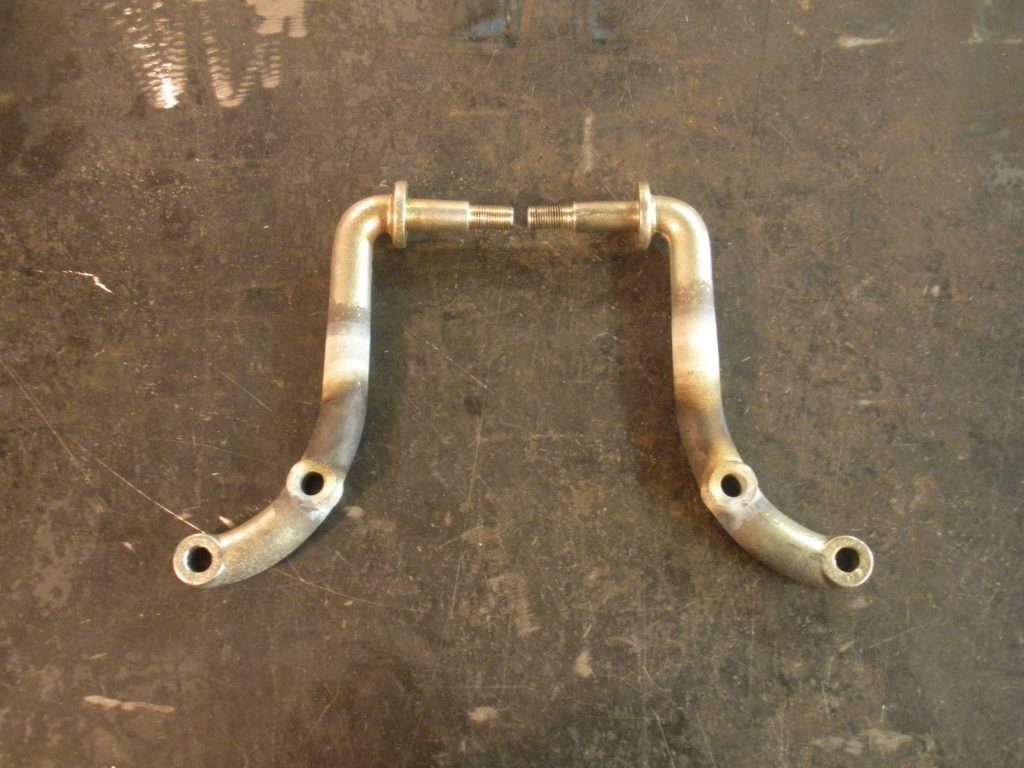 A pair of metal arms that are sitting on the ground.