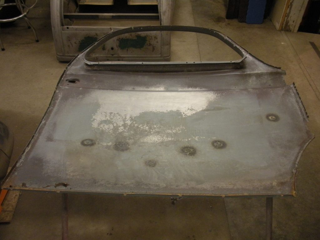 A metal piece of art that is sitting on the floor.
