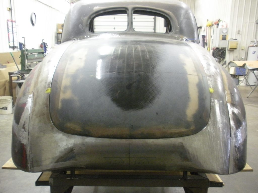 A close up of the back end of an old car.