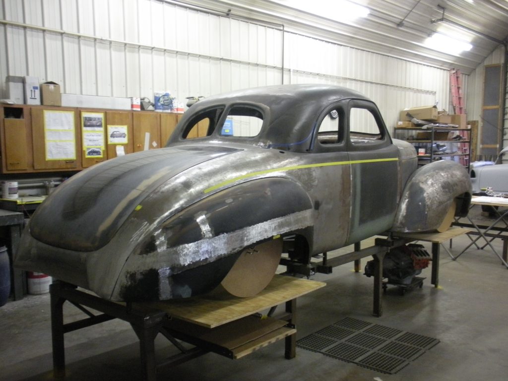A car is being worked on in the shop.