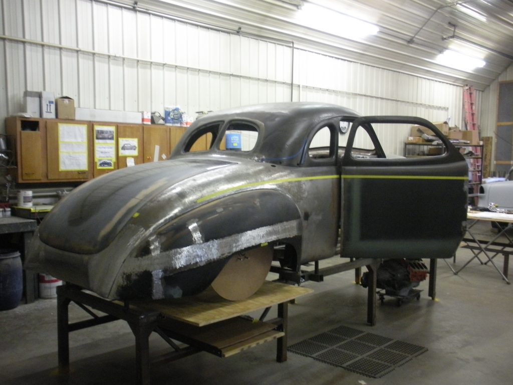 A car is being worked on in the shop.