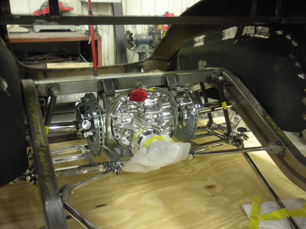 A car is being worked on in the shop.