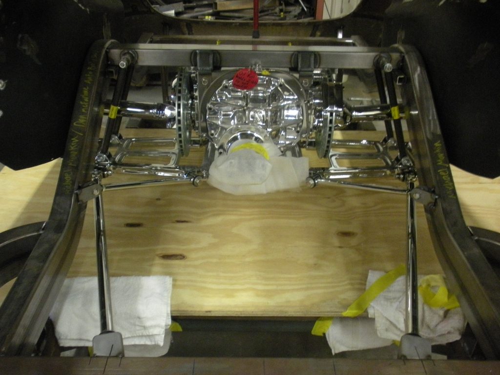 A large engine sitting on top of a wooden floor.