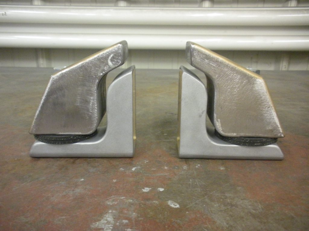 A pair of metal bookends sitting on top of a floor.