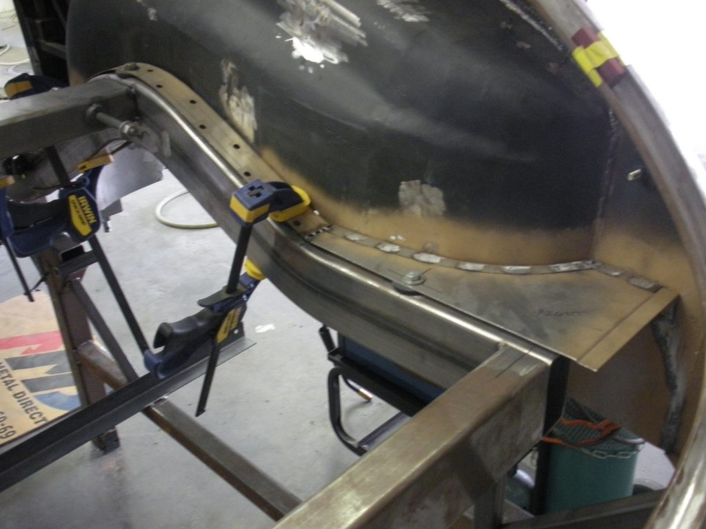 A metal piece of art is being worked on.