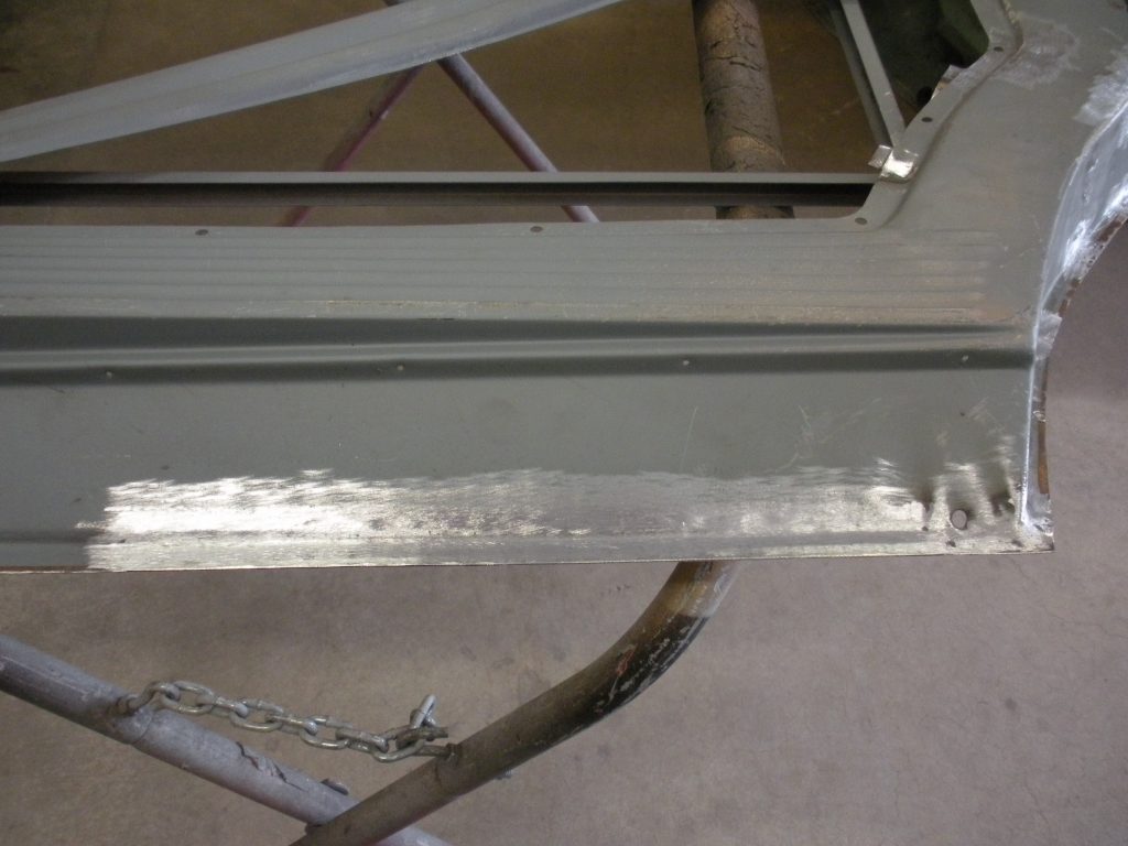 A metal structure with chains hanging from it.