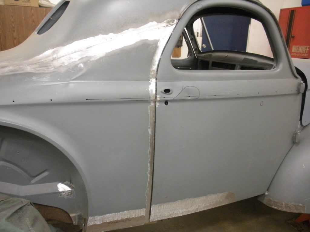 A car that is sitting in the dirt.