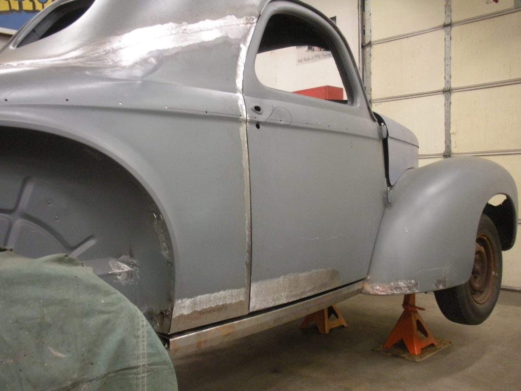 A car that is being worked on in the garage.