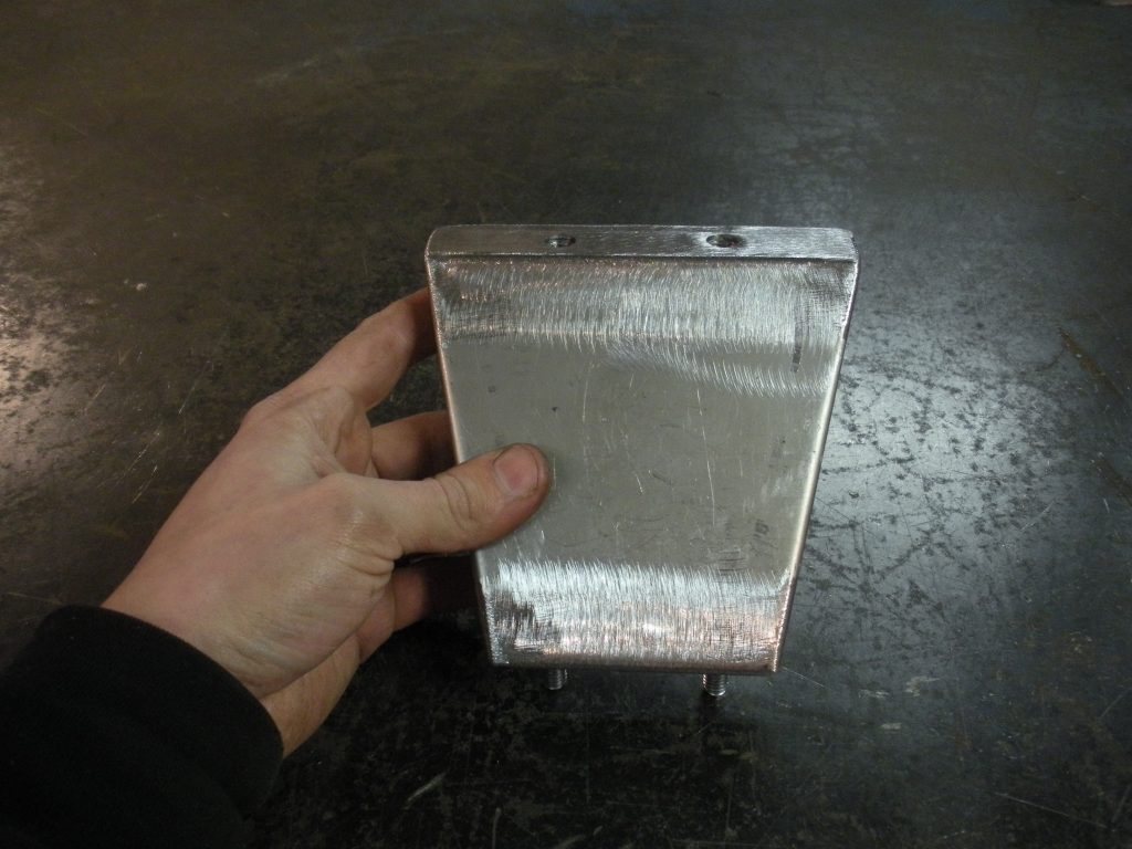 A person holding an aluminum foil box