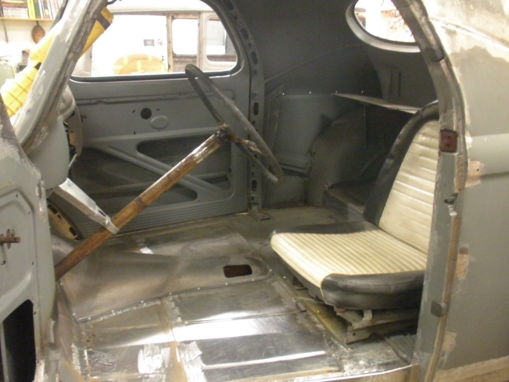 A small airplane with the door open and seats in it.