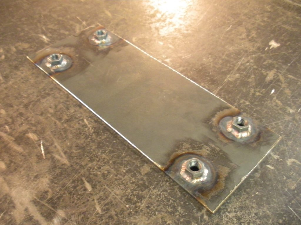 A metal board with nuts and bolts on it