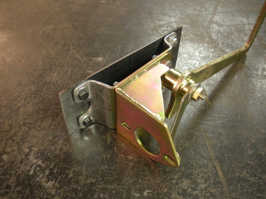 A metal device with a handle on the ground.