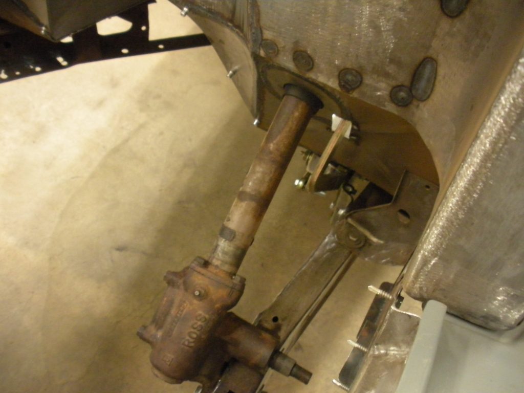 A close up of the front axle on an old car.