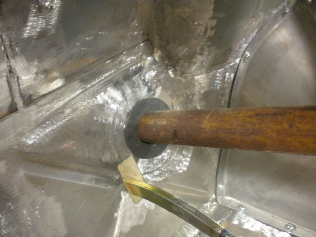 A hammer is being used to break the metal.