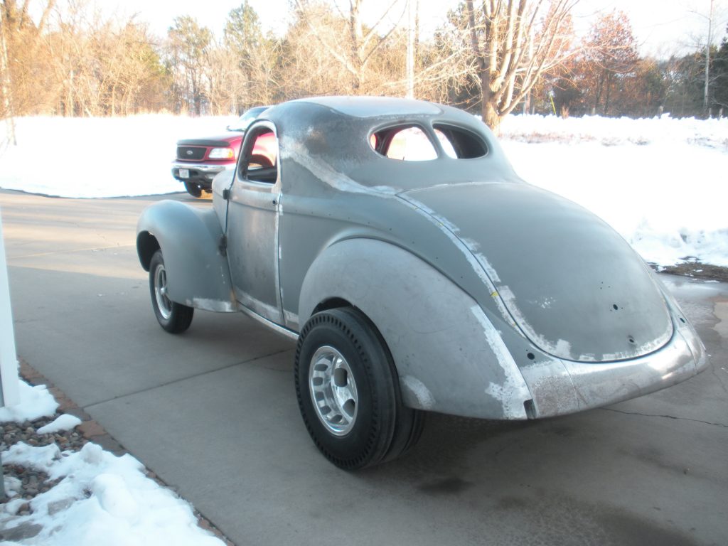 A car that is sitting in the street.