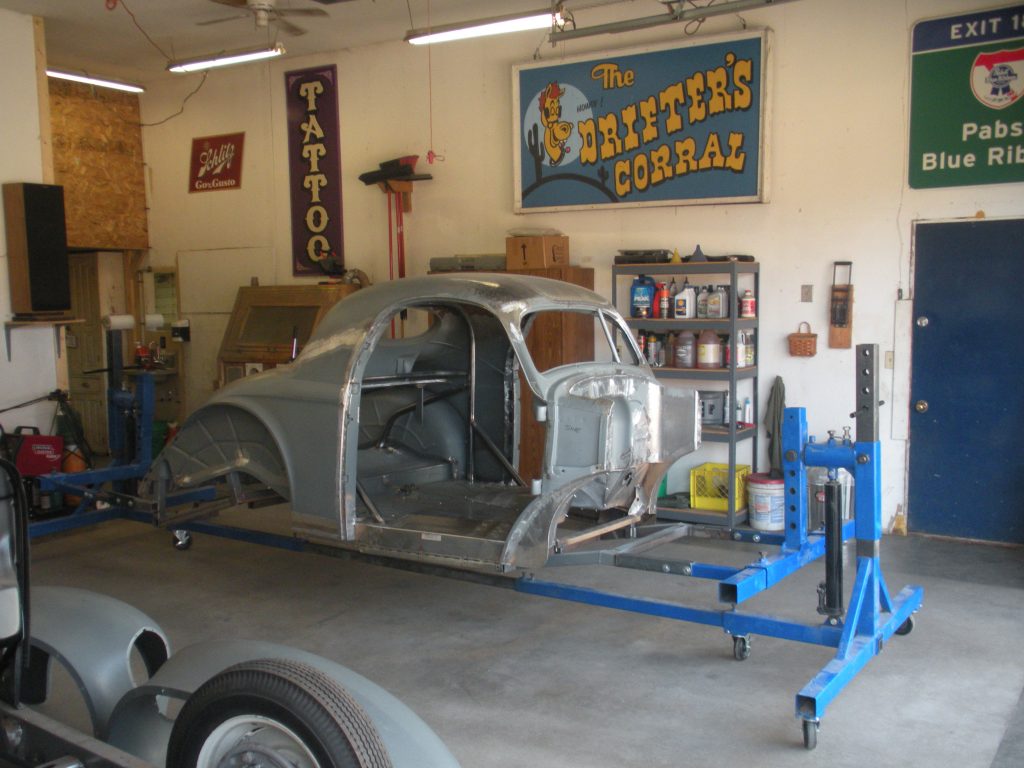 A car is being worked on in the garage.