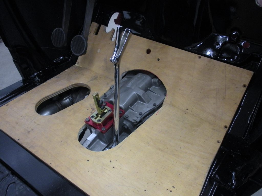 A table with a plant in it and some tools