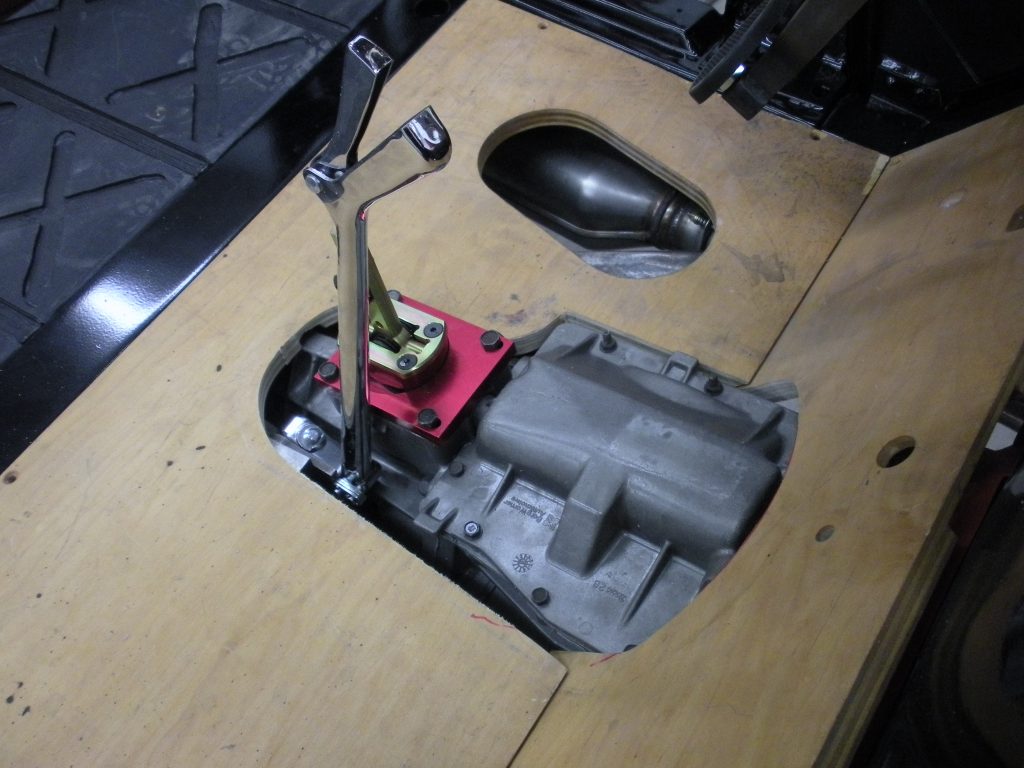 A car shifter and other parts are on the table.