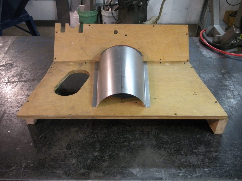 A piece of wood with metal parts on it.