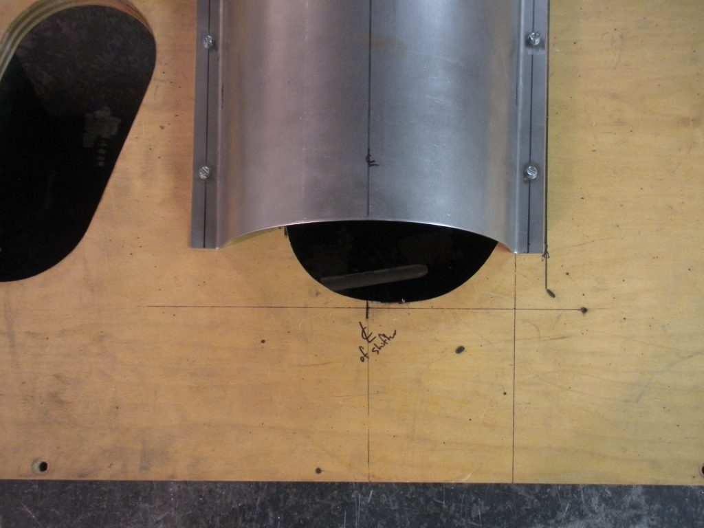 A metal pipe sitting on top of a wooden floor.