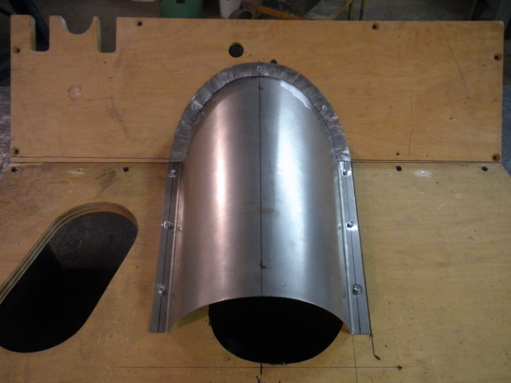 A metal piece of art is shown on the wall.