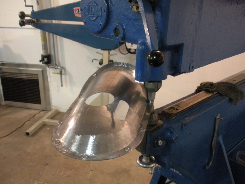 A machine is cutting the metal part.