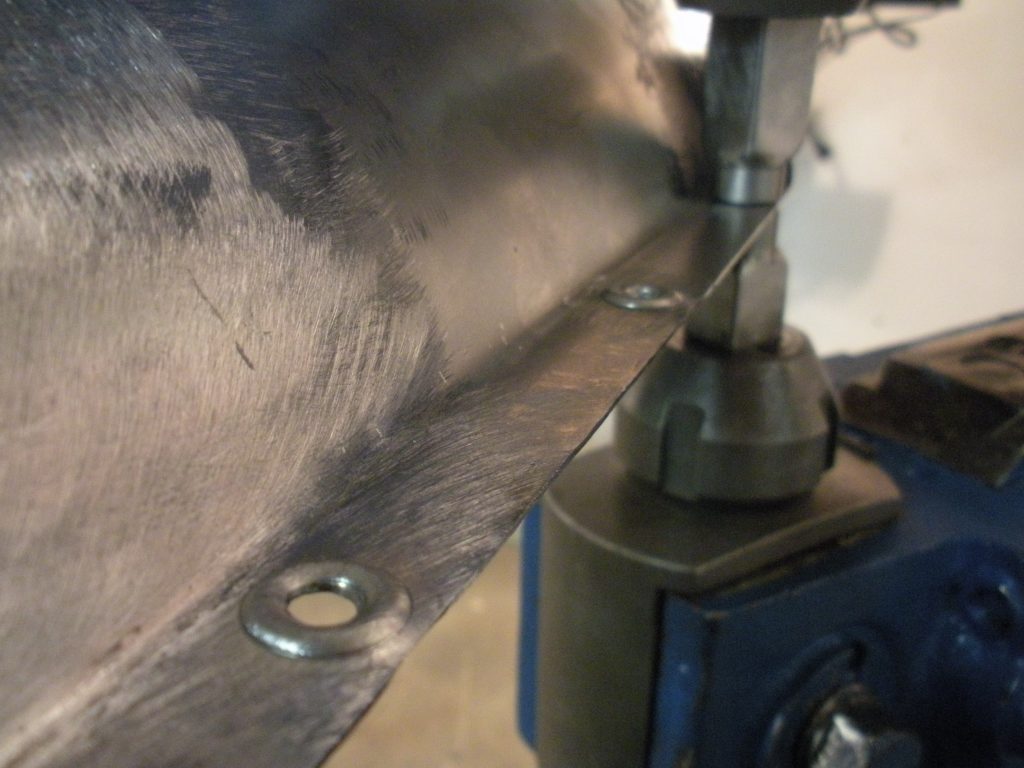 A close up of the drill press and its blade.