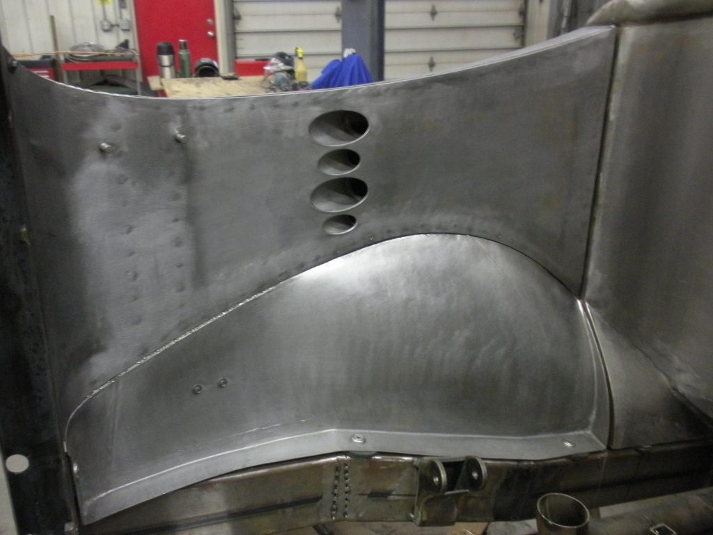 Metal car body panel in progress.