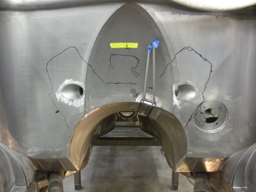 Metal part with markings and measuring tools.