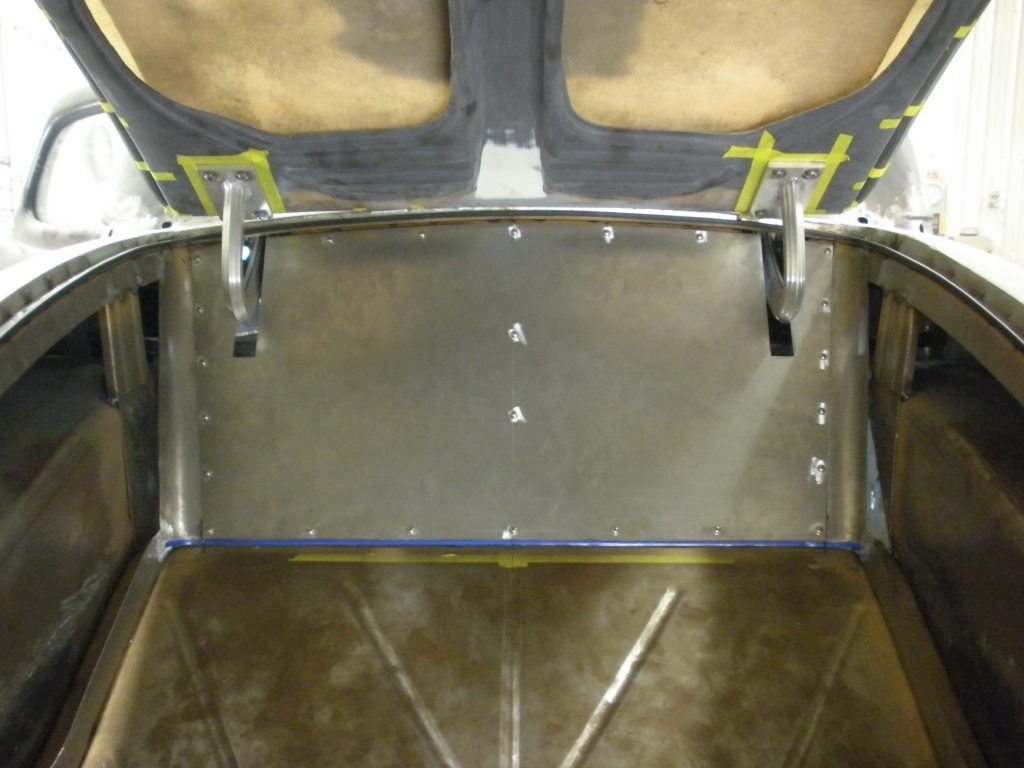Here's an alt tag for the image: Aluminum panel installed in car hood.