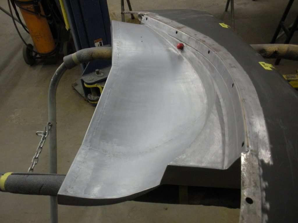 Primed car body panel in progress.