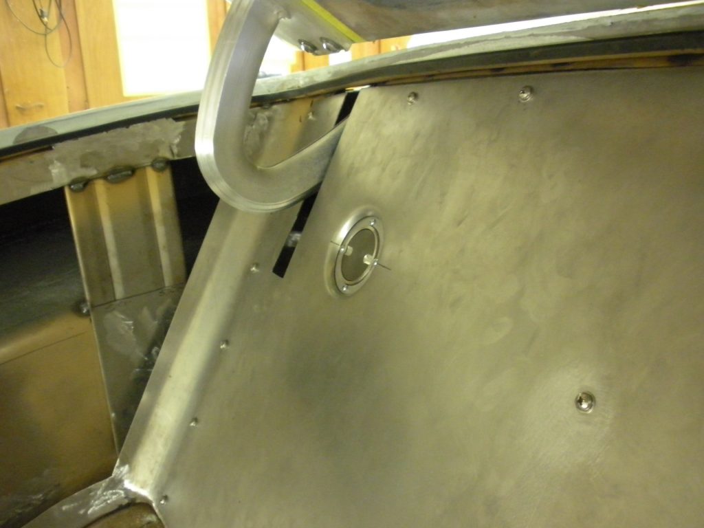 Metal panel with bolted access hole.