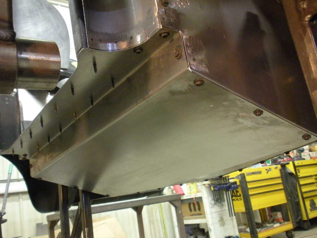 Metal panel attached with screws.