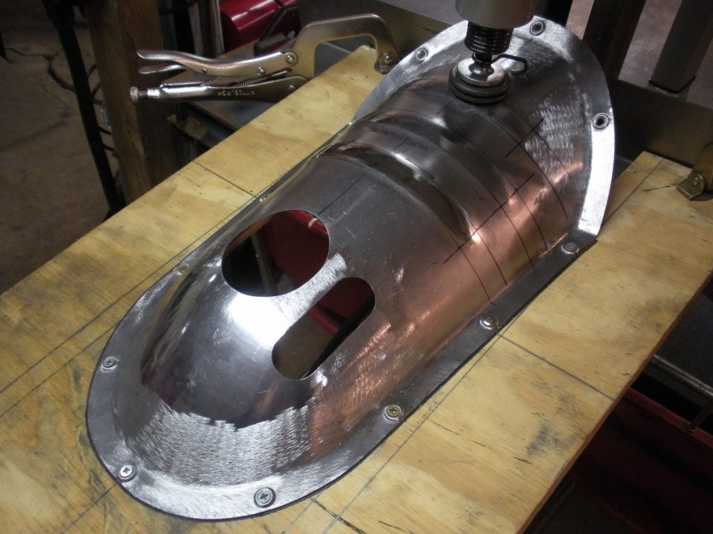 A metal object sitting on top of a wooden table.