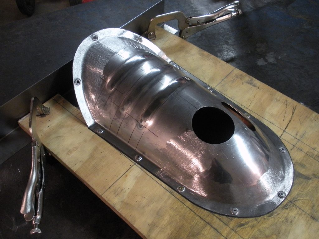 A metal object sitting on top of a wooden table.
