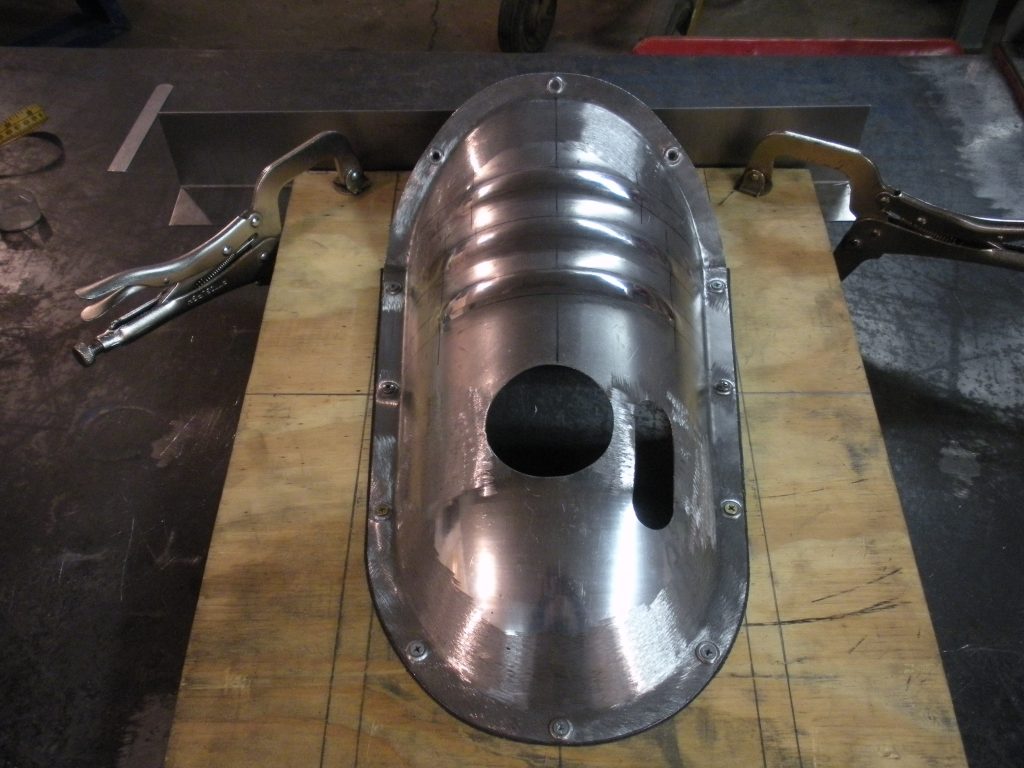 A metal object sitting on top of a wooden table.