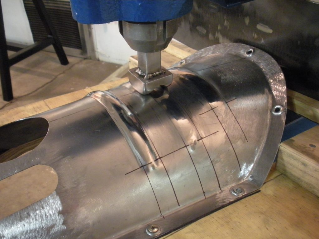 A metal part being worked on by a machine.