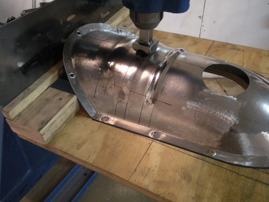 A metal piece of machinery is being worked on.