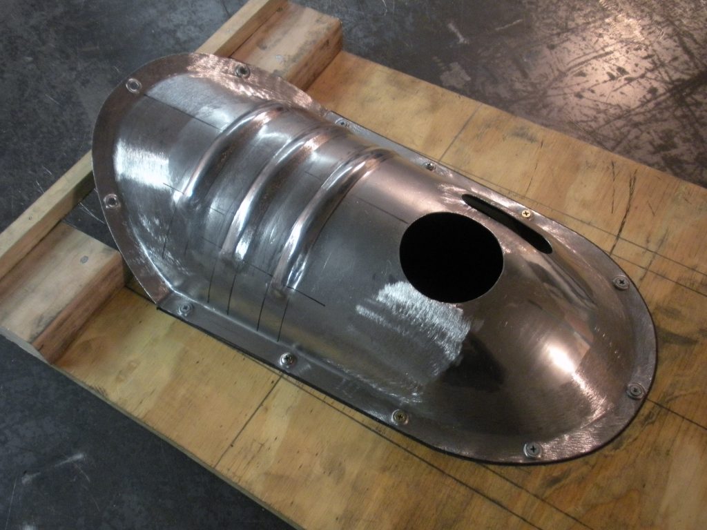 A metal object sitting on top of a wooden floor.