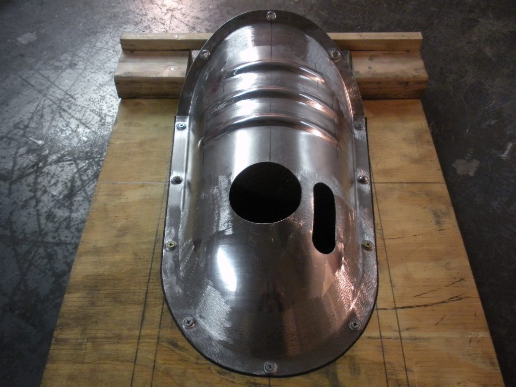 A metal object sitting on top of a wooden floor.