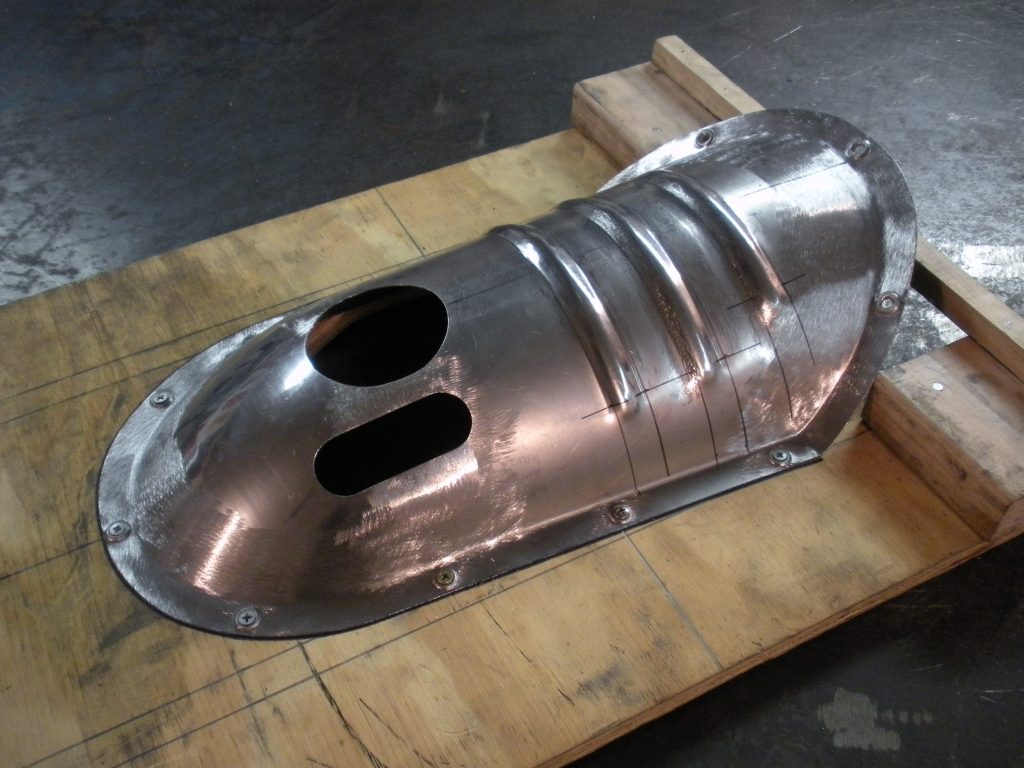 A metal object sitting on top of a wooden table.