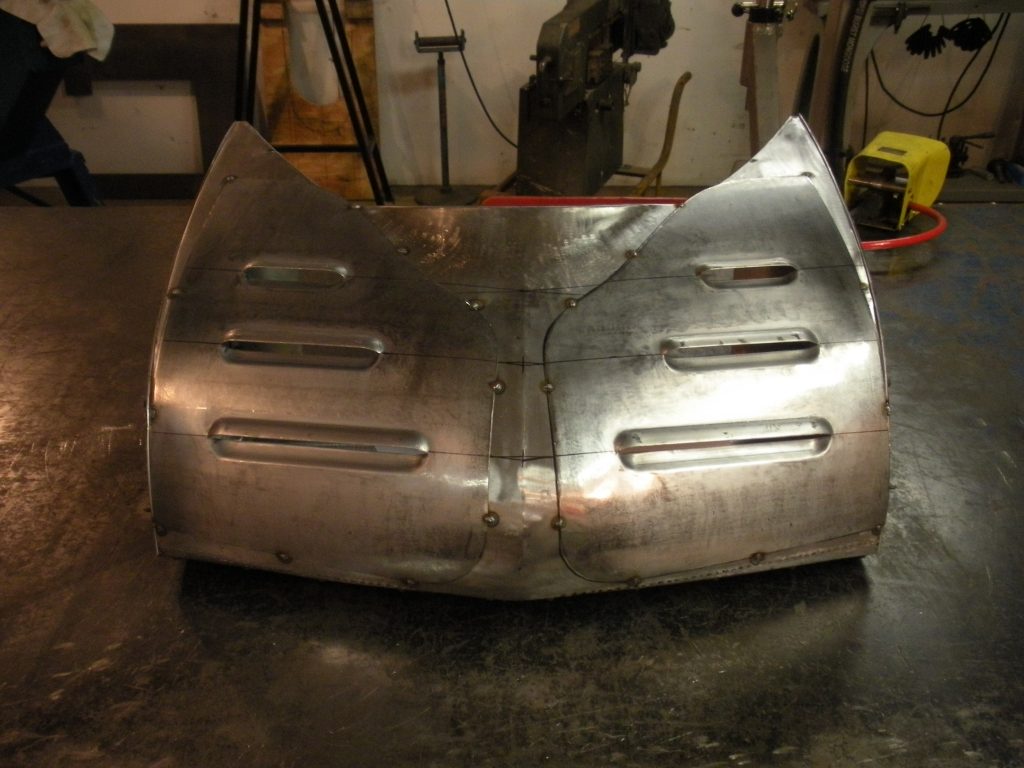Metal car part under construction.
