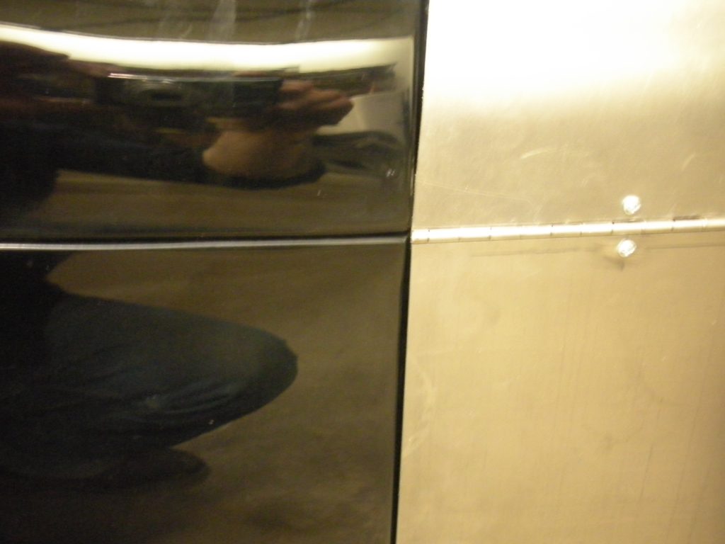 A mirror reflecting the reflection of a cat.