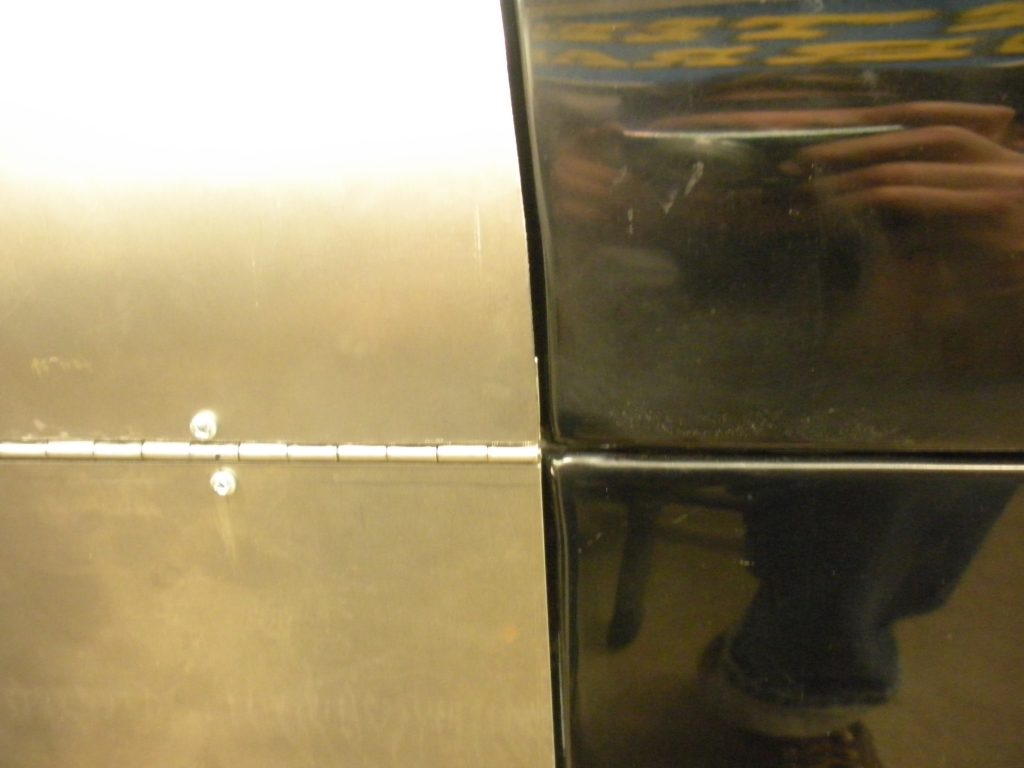 A close up of the wall with two mirrors