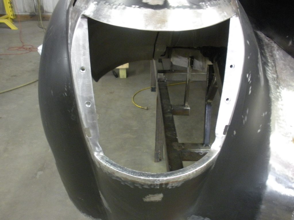 Car fender with welded metal section.