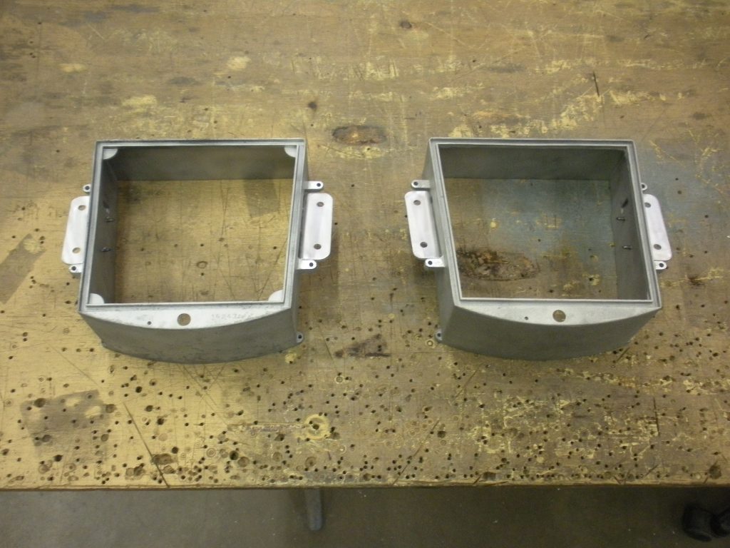 Two metal empty boxes on a table.