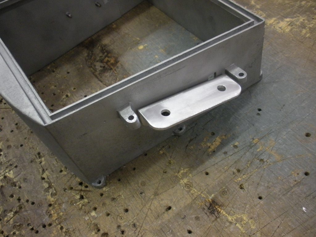 Metal box with attached bracket.