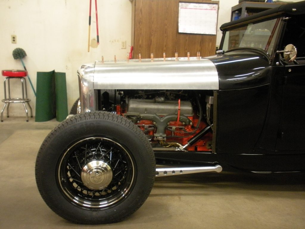 A black and silver car with a tire on the floor