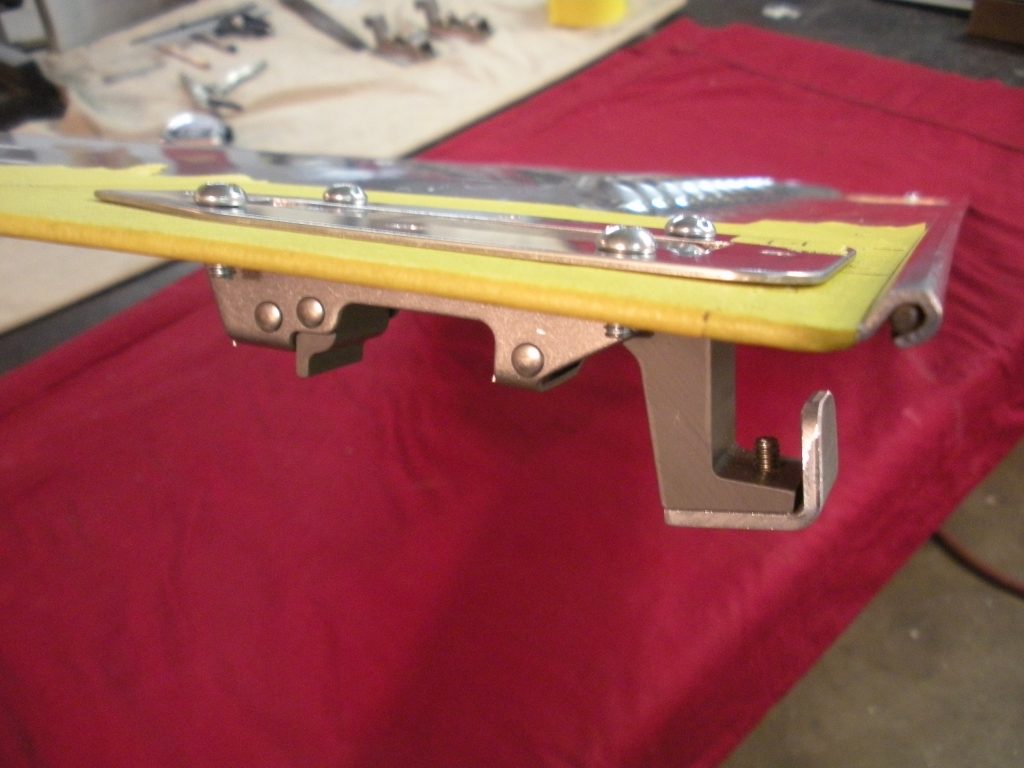 A red table with a yellow board and some tools